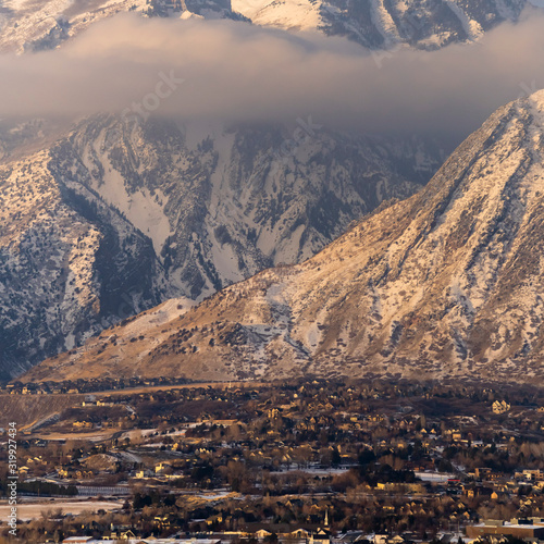 Square frame Snow covered Mount Timpanogos with residential landscape in the foreground