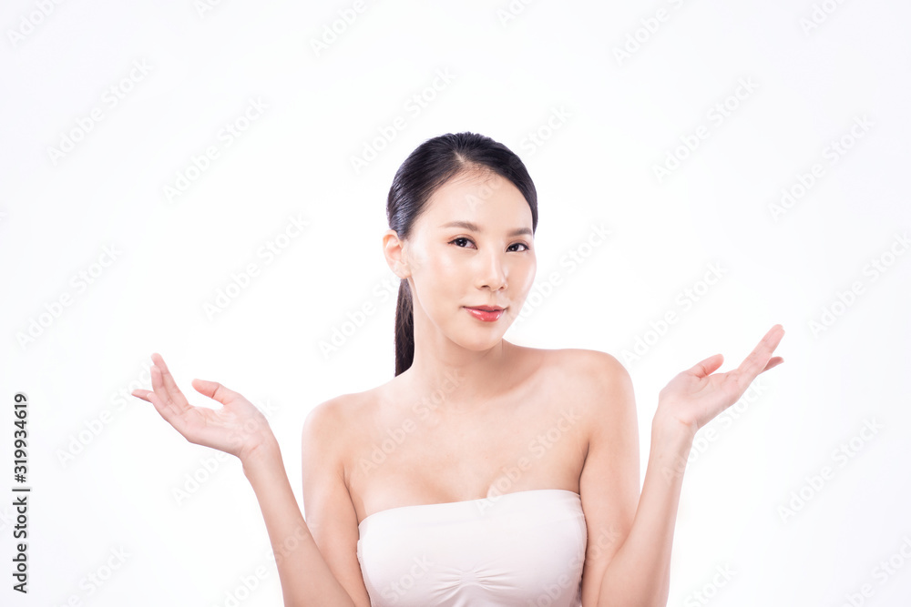 Beautiful Young Asian woman with clean fresh white skin raising hands in beauty pose, showing advertisement product above gesture white background. Facial treatment, cosmetology, spa, make up concept. Beautiful Young Asian woman with clean fresh white skin raising hands in beauty pose, showing advertisement product above gesture white background. Facial treatment, cosmetology, spa, make up concept.