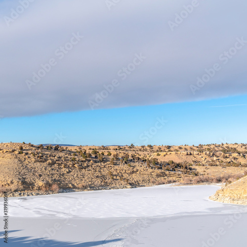Square Vast terrain covered in a sheet of fresh white snow amid hills viewed in winter