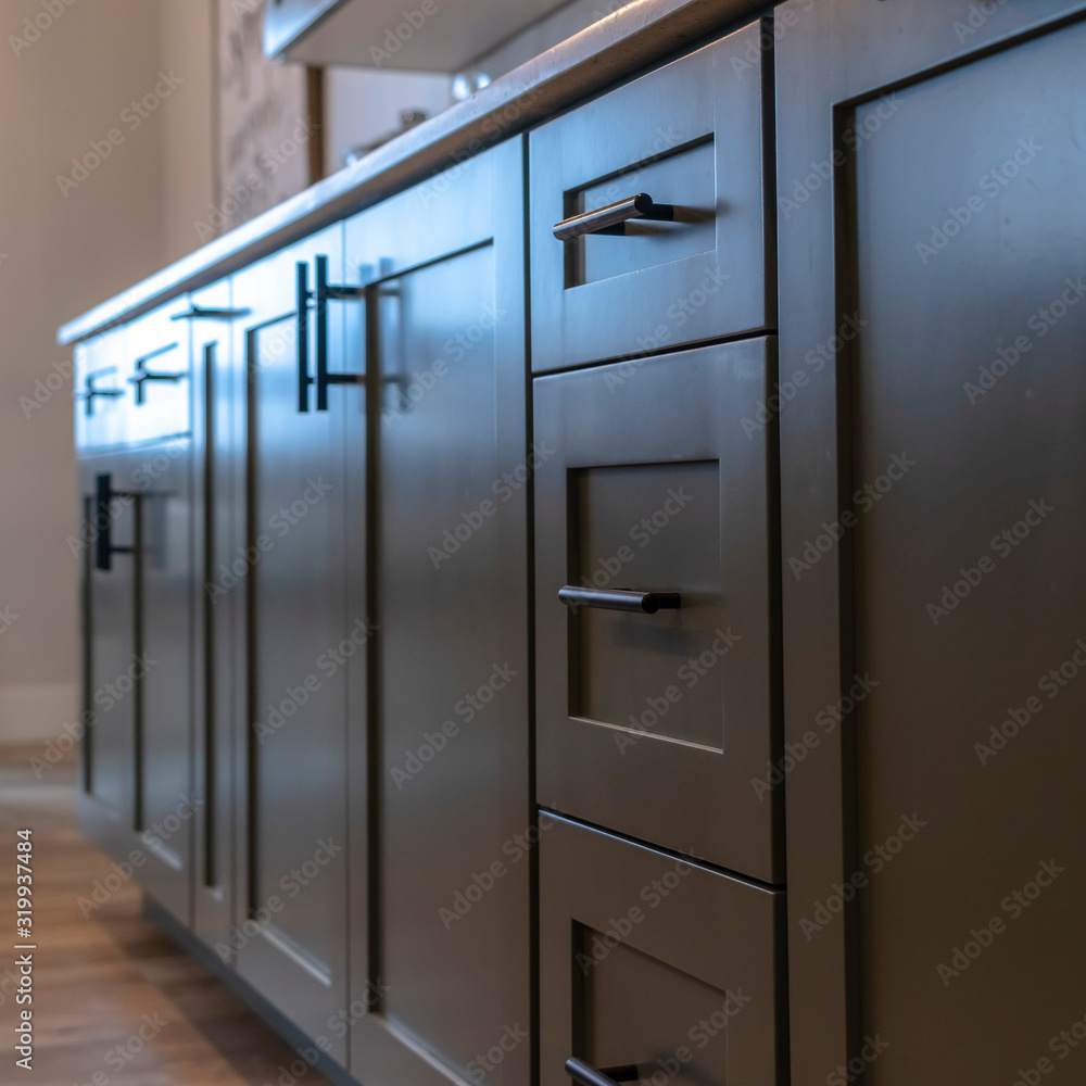 Square Beautiful cabinetry with black handles and drawers under white countertop Square Beautiful cabinetry with black handles and drawers under white countertop