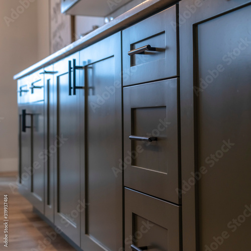 Square Beautiful cabinetry with black handles and drawers under white countertop