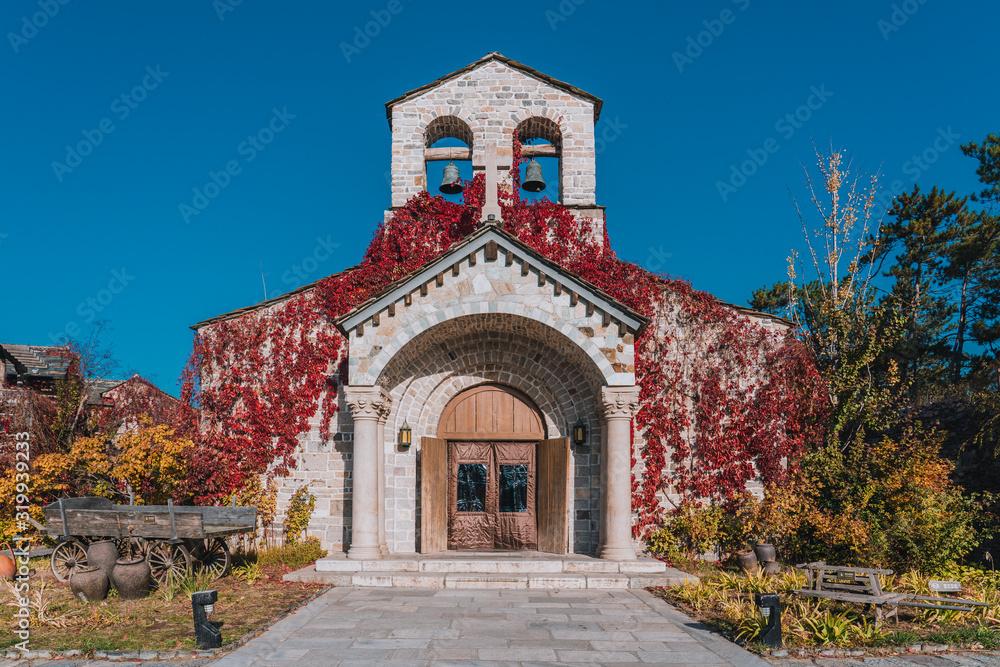 The church at the top of the mountain with red leaves in autumn in Beijing WTown（gubeishui Town）, China