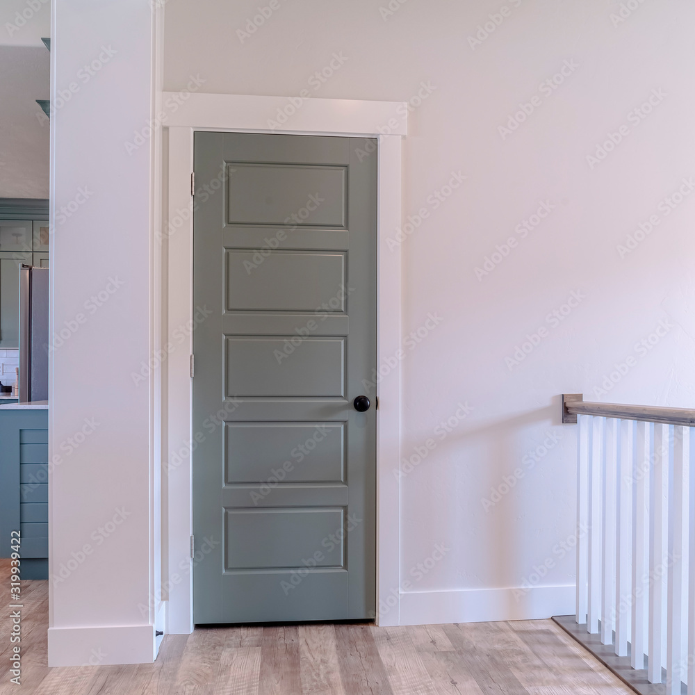 Square frame Interior of house with gray door white wall and brown wooden floor Square frame Interior of house with gray door white wall and brown wooden floor