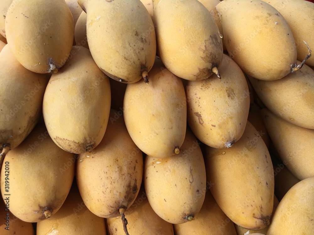 Thailand's barracuda mangoes on shelf beside street market. Thailand's barracuda mangoes on shelf beside street market.