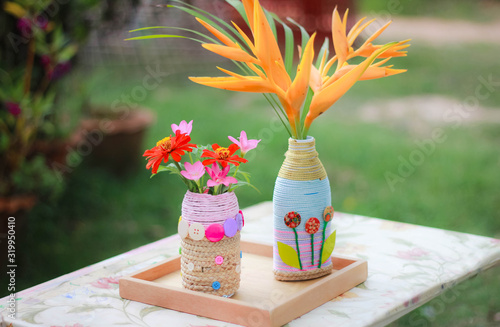 A 6-year-old Asian child doing crafts D.I.Y. Flower Vases from Waste Materials , Crafts for kids, Children making flower vases.
