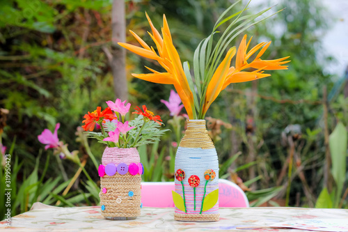 A 6-year-old Asian child doing crafts D.I.Y. Flower Vases from Waste Materials , Crafts for kids, Children making flower vases.