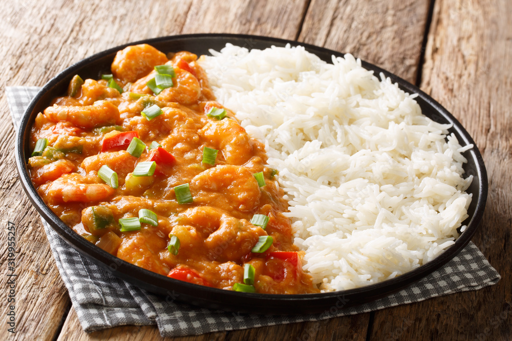 Spicy traditional shrimp Etouffee with celery, onion and pepper with sauce served with rice closeup in a plate. horizontal Spicy traditional shrimp Etouffee with celery, onion and pepper with sauce served with rice closeup in a plate. horizontal