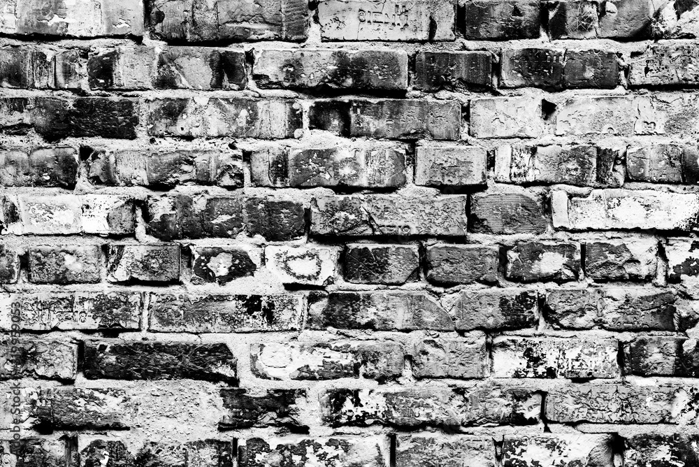 Texture of a brick wall with cracks and scratches which can be used as a background Texture of a brick wall with cracks and scratches which can be used as a background