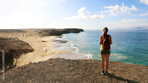 Female hiker enjoying view of Playas de Papagayo beaches in Lanz
