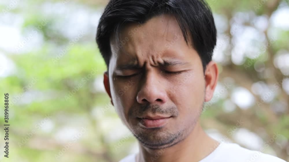 Asian man cough and wearing protective mask to protect against germs and air pollution , health care concept Asian man cough and wearing protective mask to protect against germs and air pollution , health care concept