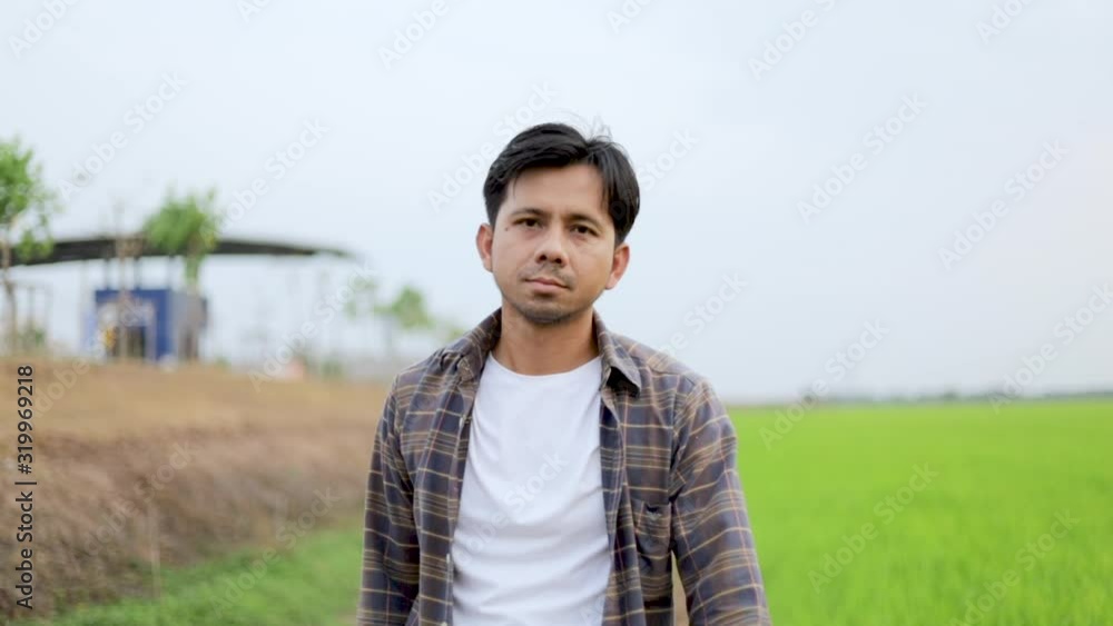 Young Asian farmer smiling and looking camera outdoor slow motion Young Asian farmer smiling and looking camera outdoor slow motion