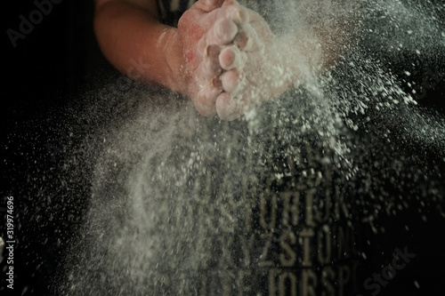 women's hands sift the flour