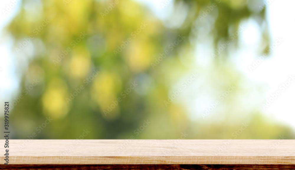 blurred background of green park in summer, Wood table top on shiny bokeh green background. For product display blurred background of green park in summer, Wood table top on shiny bokeh green background. For product display