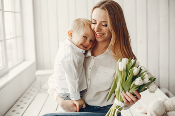 Children give mother flowers. Family at home. Mothers day