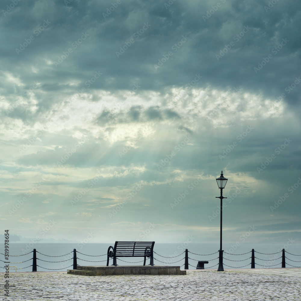 Lonely empty bench seat coastal sea storm but peaceful quiet mindfulness scene view