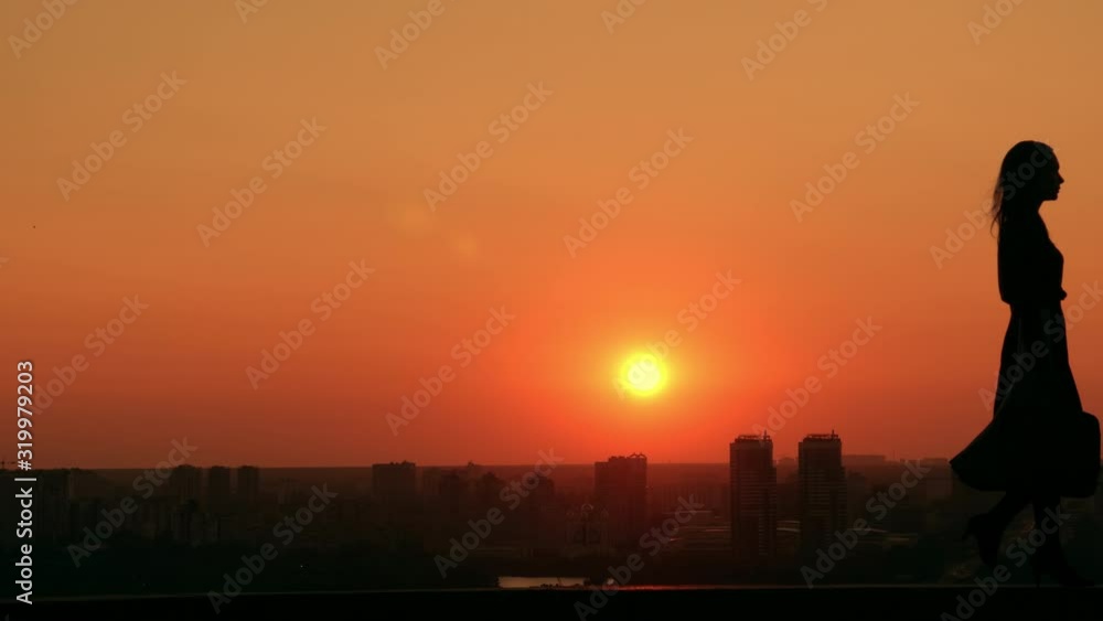 businesswoman with bag walks outdoors scenic town in early morning view on urban architecture and bridge with cars businesswoman with bag walks outdoors scenic town in early morning view on urban architecture and bridge with cars