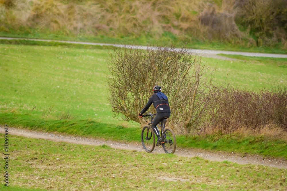 mature man mountain biking in country lanes
