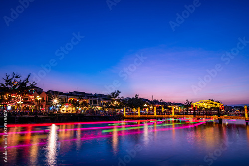 Nightscape at Hoi An old town with passenger boat light trails