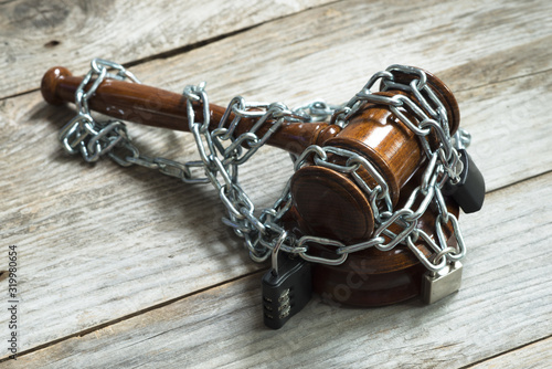 legal corrupt system concept with judge gavel or hammer chained with lockers