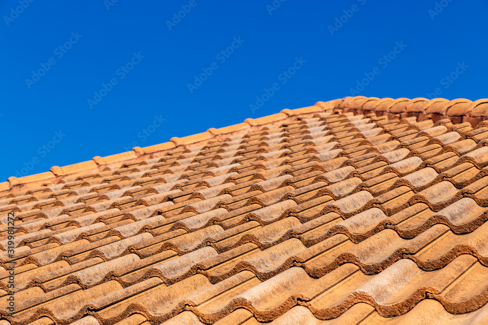 Close up of brown clay roof tiles. Red old dirty roof. Old roof tiles. Construction equipment build a house. Close up of brown clay roof tiles. Red old dirty roof. Old roof tiles. Construction equipment build a house.