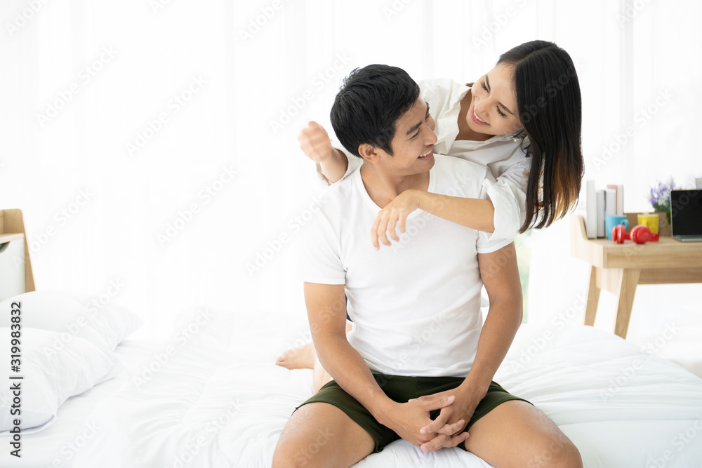 Beautiful Asian couple laying and talking together on the bed. Couple relationship concept. Beautiful Asian couple laying and talking together on the bed. Couple relationship concept.