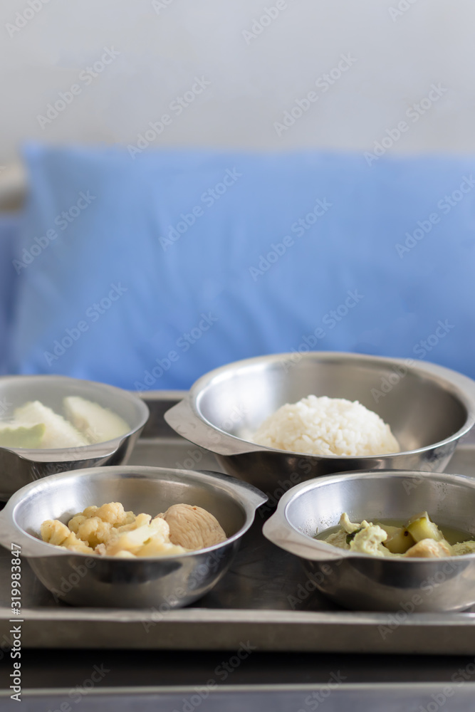 Thai Food Dishes on Tray have Steamed Rice, Green Curry with Chicken.  Stir Fried Cauliflower with Pork and Guava. Breakfast Meal for Patient.