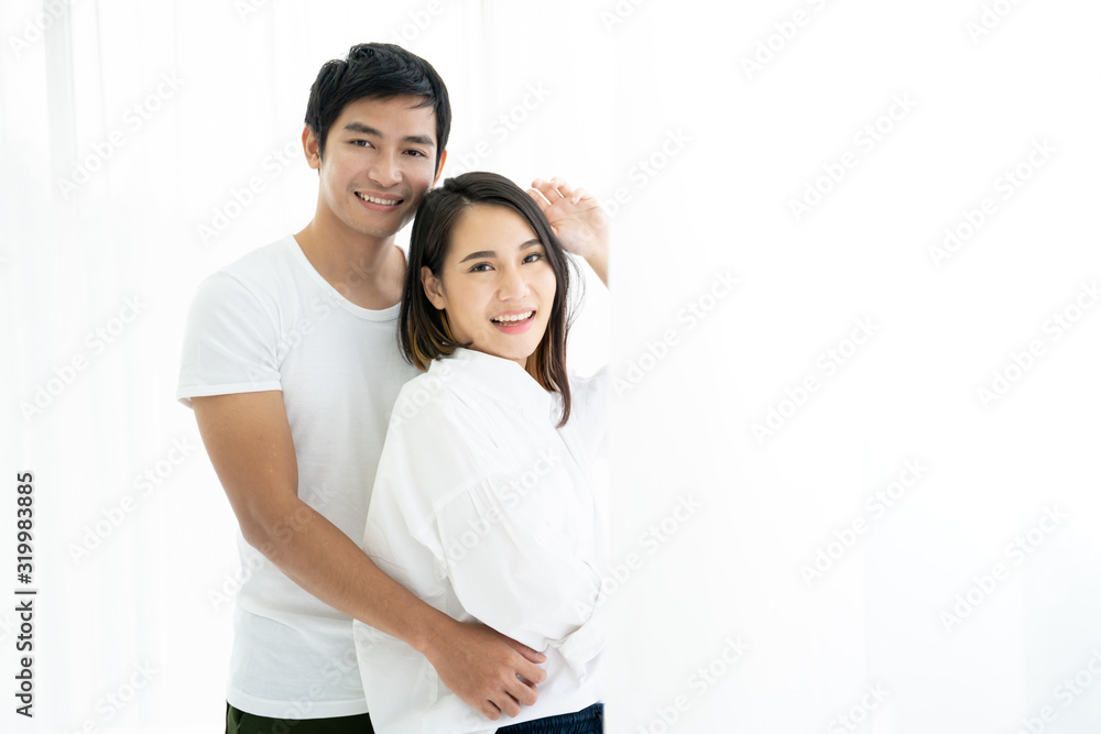 Asian young couple's portrait, a couple standing and talking near the window in the morning. Asian young couple's portrait, a couple standing and talking near the window in the morning.