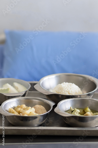 Thai Food Dishes on Tray have Steamed Rice, Green Curry with Chicken. Stir Fried Cauliflower with Pork and Guava. Breakfast Meal for Patient.