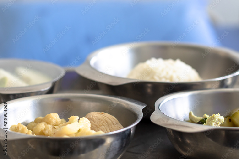 Thai Food Dishes on Tray have Steamed Rice, Green Curry with Chicken. Stir Fried Cauliflower with Pork and Guava. Breakfast Meal for Patient. Thai Food Dishes on Tray have Steamed Rice, Green Curry with Chicken. Stir Fried Cauliflower with Pork and Guava. Breakfast Meal for Patient.