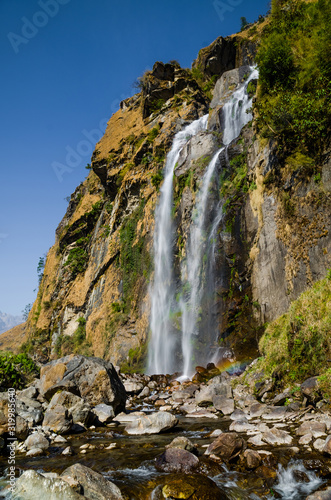 Waterfall in Tal village in Marshyangdi river valley. Annapurna circuit trek, Nepal.