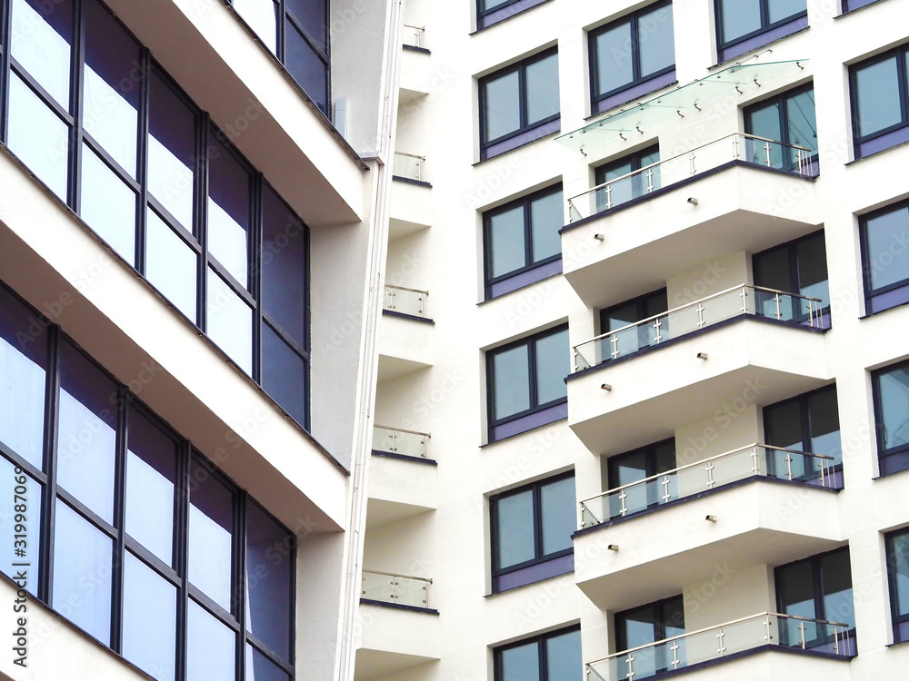 The windows of a multistory building are angled. fragment of a multi-storey residential building The windows of a multistory building are angled. fragment of a multi-storey residential building