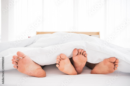 Young Asian couple sleeping on the bed together.