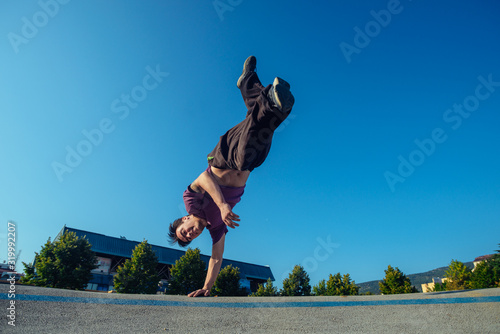Well built person doing a handstand