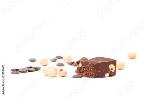 Fudge on a white plate with nuts and chocolate diced