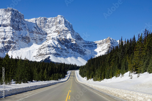 POV: Driving along the famous Icefields Parkway route on a sunny winter day.