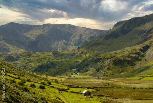 View toward the Glyderau mountain range along the Nant Ffrancon pass in Snowdonia National Park in North Wales UK photo