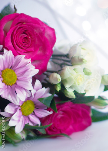 Delicate floral background with copy space under the text. Blurred background with spring flowers, bokeh. Bouquet of flowers close-up