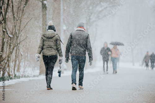 two couple people walking in snow  park amsterdam holland