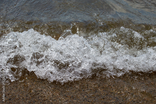 waves foam on the lake photo