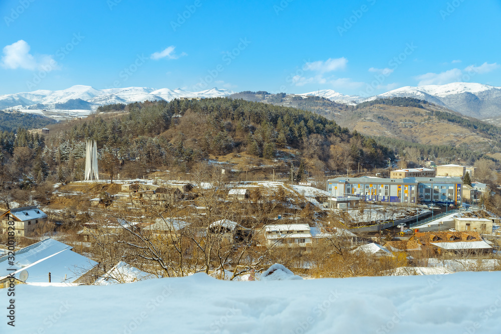 old village beside snowcapped mountains