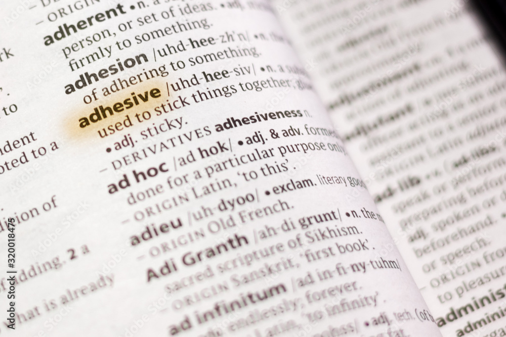 The word or phrase Adhesive in a dictionary. foto de Stock Adobe Stock