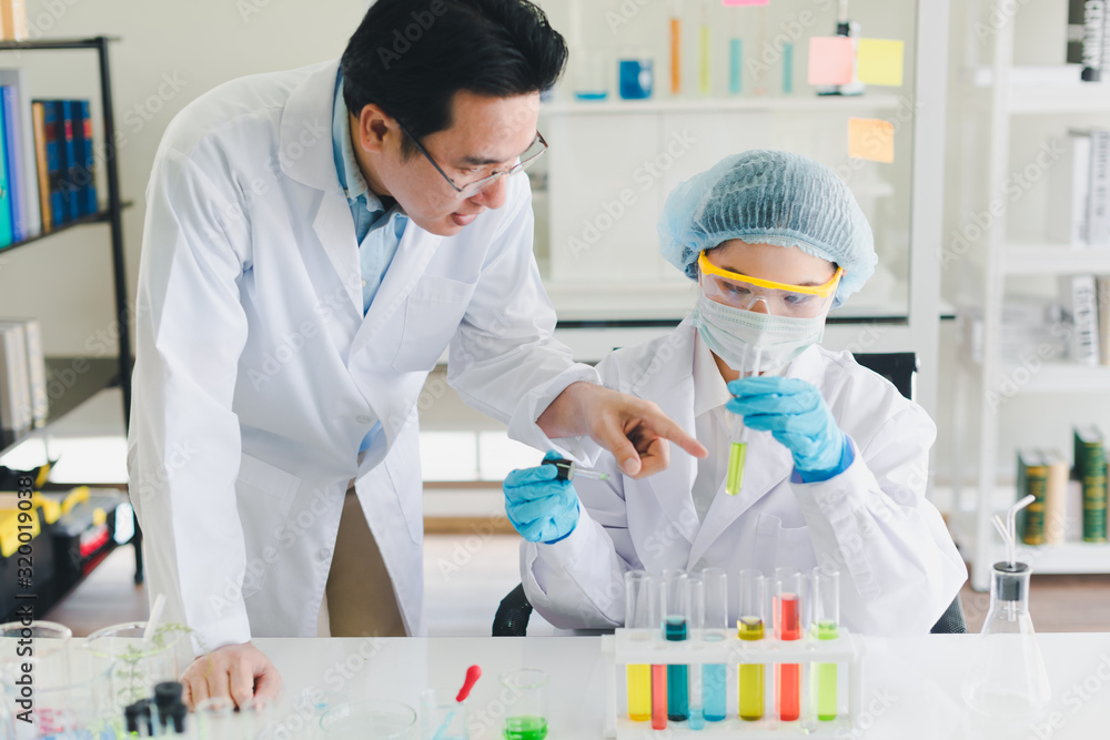 Asian scientists, men and women are helping to test and analyze various color chemicals in laboratories that have many scientific equipment. Asian scientists, men and women are helping to test and analyze various color chemicals in laboratories that have many scientific equipment.