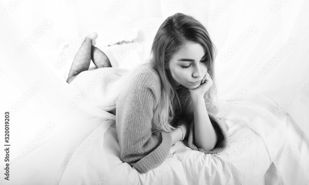 Young girl in a sweater in a room Young girl in a sweater in a room