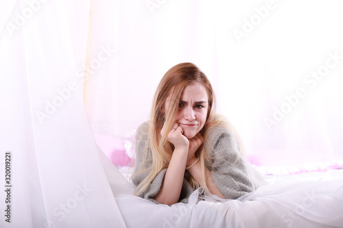 Girl with blond hair and gray sweater