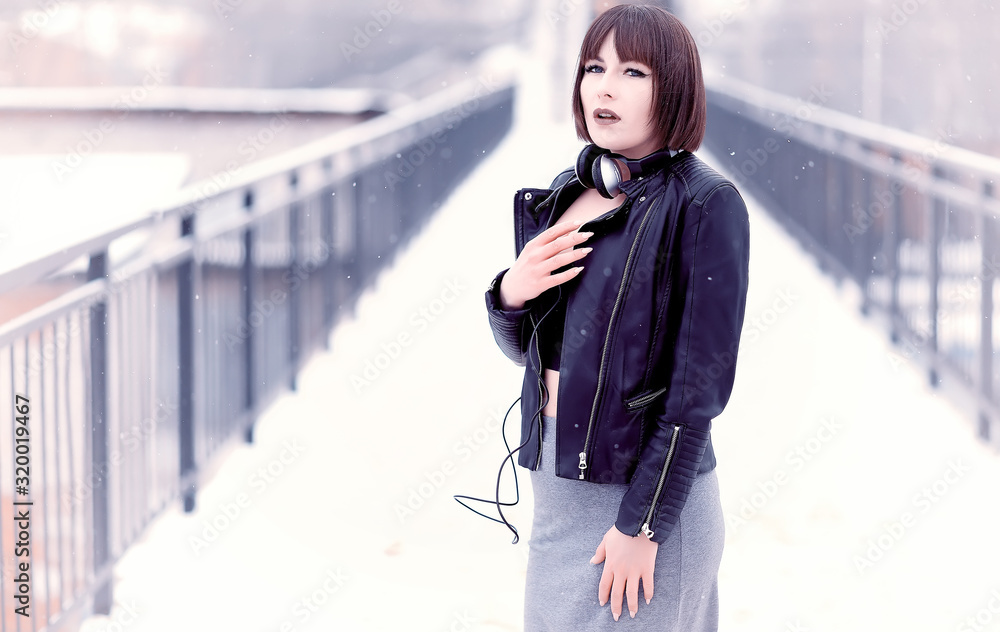 Obraz premium Girl in headphones listening to music outdoors