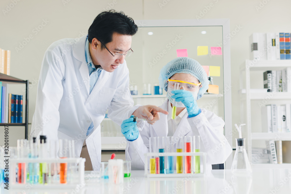 Asian scientists, men and women are helping to test and analyze various color chemicals in laboratories that have many scientific equipment. Asian scientists, men and women are helping to test and analyze various color chemicals in laboratories that have many scientific equipment.