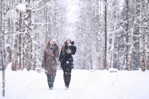 Girl in a winter park in snowfall © alexkich