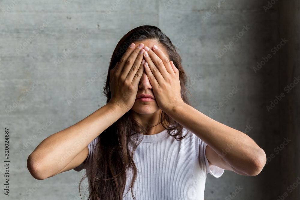 Young Woman Covering Eyes with Hands Young Woman Covering Eyes with Hands