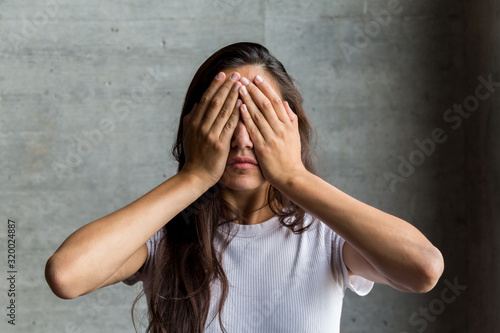 Young Woman Covering Eyes with Hands