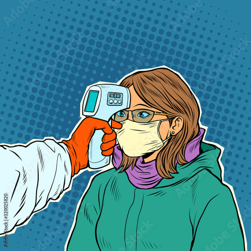 A doctor measures the temperature of a woman in a medical mask. Novel Wuhan coronavirus 2019-nCoV epidemic outbreak